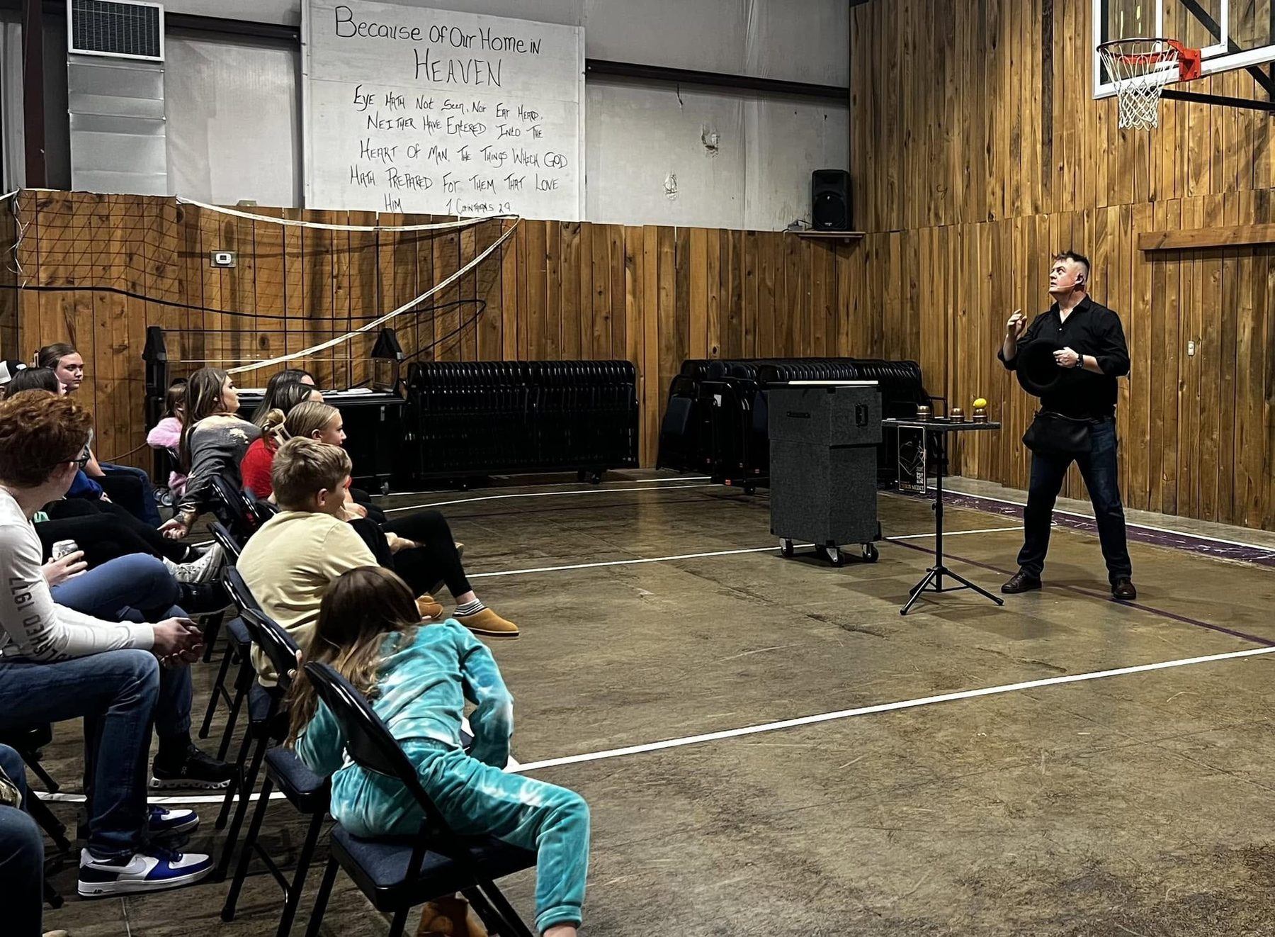 Chris Meece performing a comedy magic show for a seated church audience