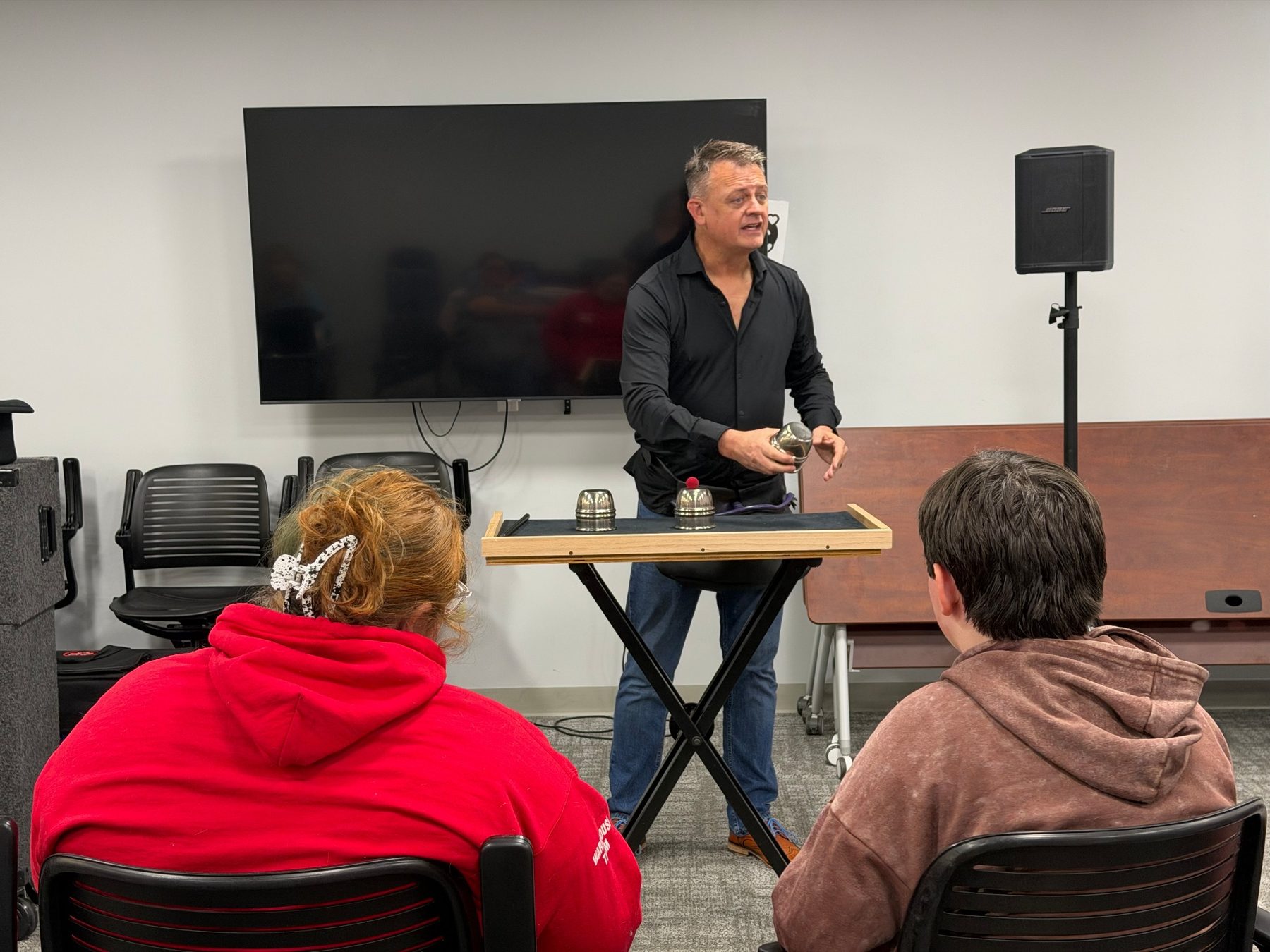 Chris Meece performing for children in a school or library
